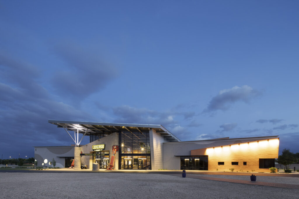 Exterior of Kids building lit up at night