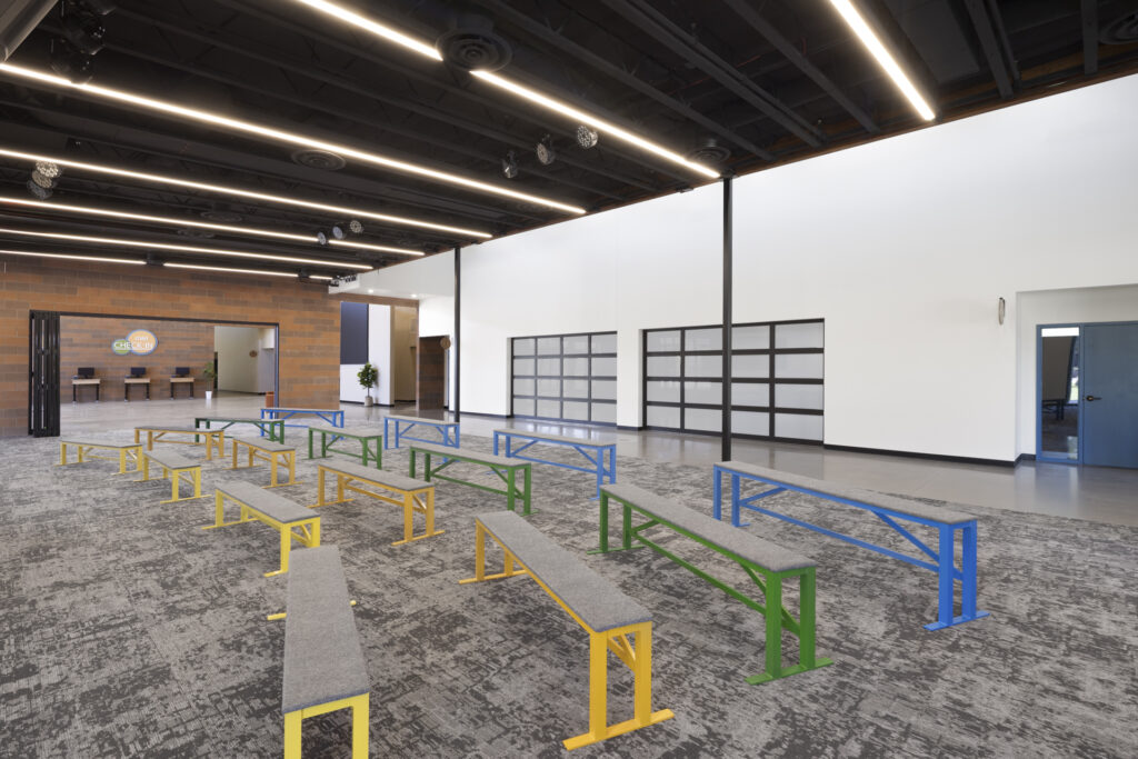 Interior of classroom building with colored benches.