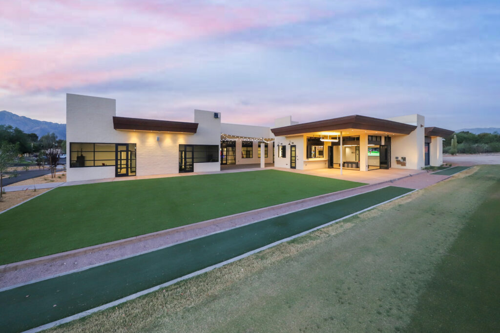 exterior of clubhouse with green lawn