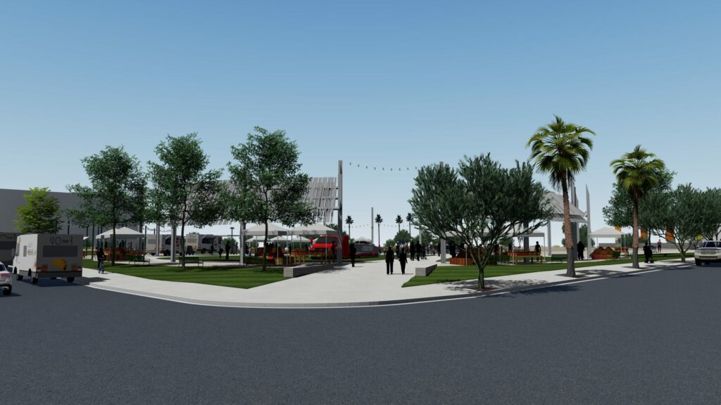 Side view of a circular outdoor park space with grass, a center walkway, and trees surrounding the perimeter.