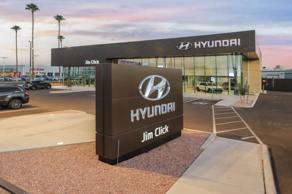 Glass exterior of Hyundai car dealership with large sign in front