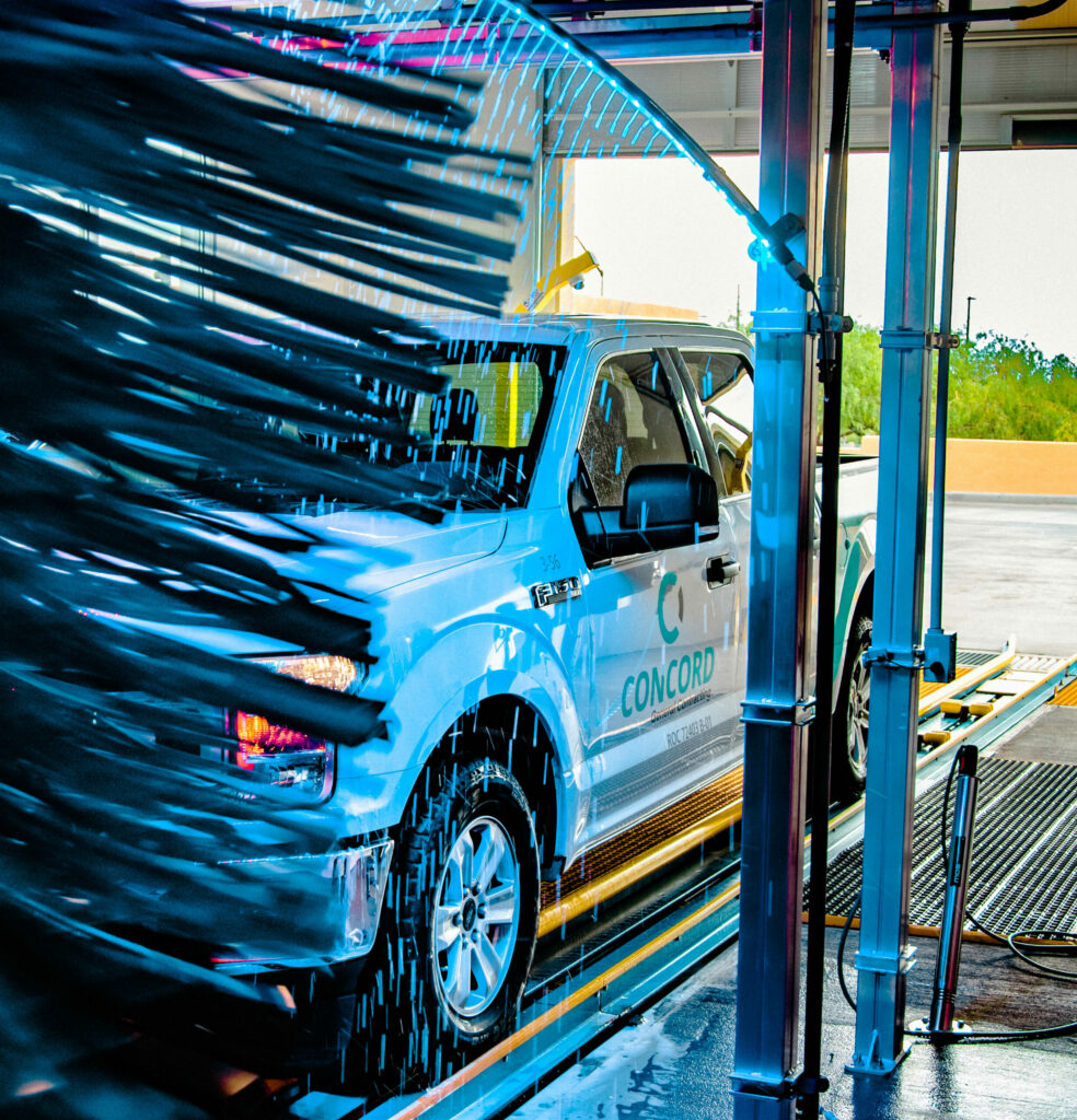 Commercial Concord truck driving through a commercial car wash tunnel.