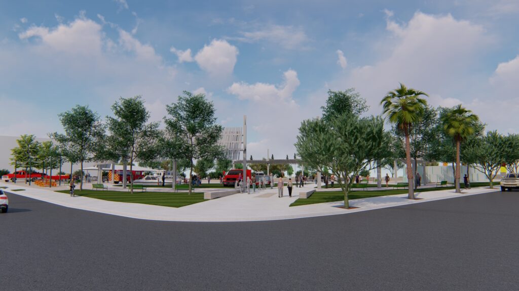 Side view of a circular outdoor park space with grass, a center walkway, and trees surrounding the perimeter.