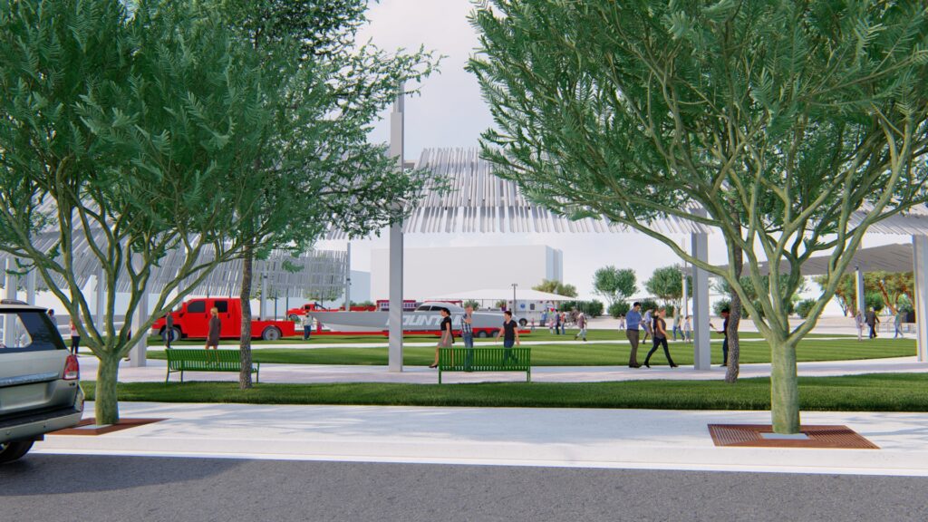 Close up side view of a circular outdoor park space with grass, a center walkway, and trees surrounding the perimeter.