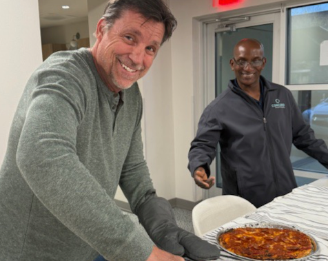 Employee Owners cutting pizza
