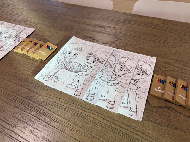 crayons and coloring sheets laid out on table