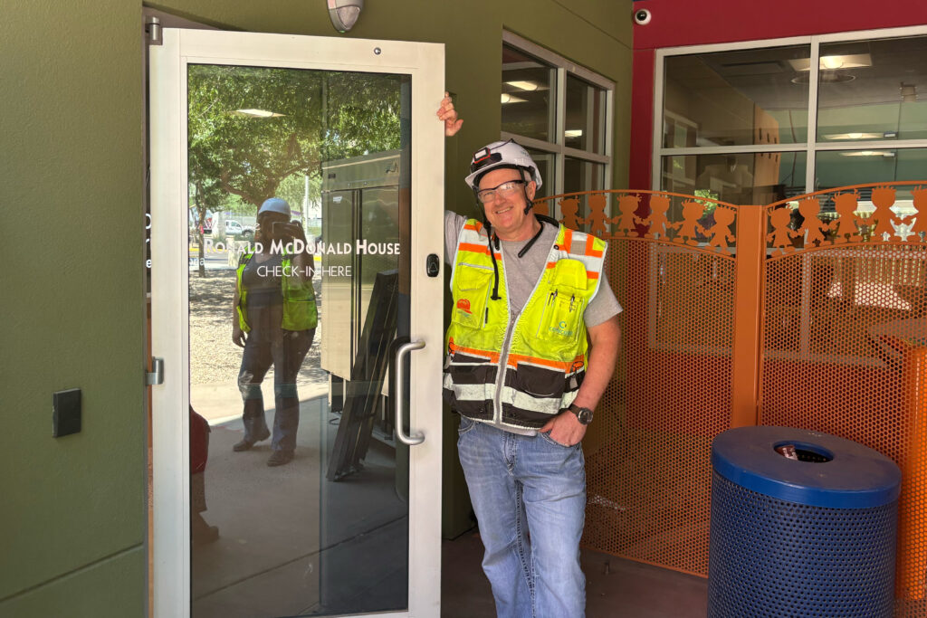 ron alderman, a superintendent propping the door open at his project Ronald McDonald House